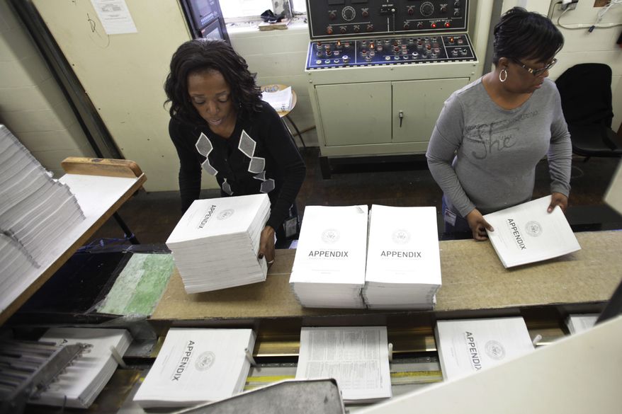 Willow Wimbush, left, and Nancy Harris, work on copies of the Appendix of the 2012 budget at the U.S. Government Printing Office at Washington on Feb. 10, 2011. President Obama will send his 2012 budget proposal to Congress on Monday, Feb. 14. (AP Photo/Jacquelyn Martin)