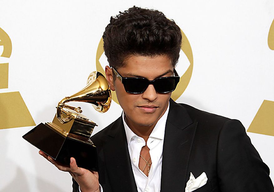 Bruno Mars poses backstage with the award for best male pop vocal performance at the 53rd annual Grammy Awards on Sunday, Feb. 13, 2011, in Los Angeles. (AP Photo/Jae C. Hong)