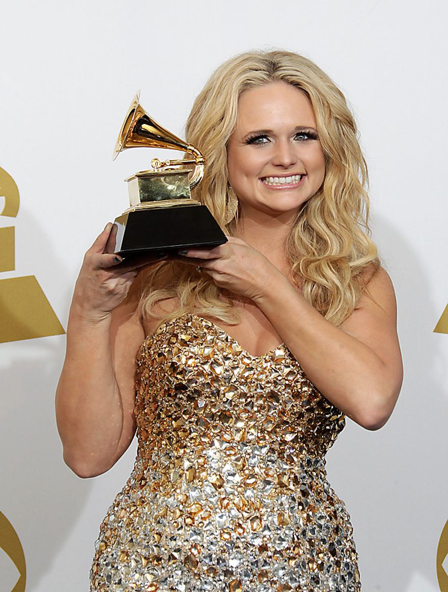 Miranda Lambert poses backstage with the award for best female country vocal performance at the 53rd annual Grammy Awards on Sunday, Feb. 13, 2011, in Los Angeles. (AP Photo/Jae C. Hong)