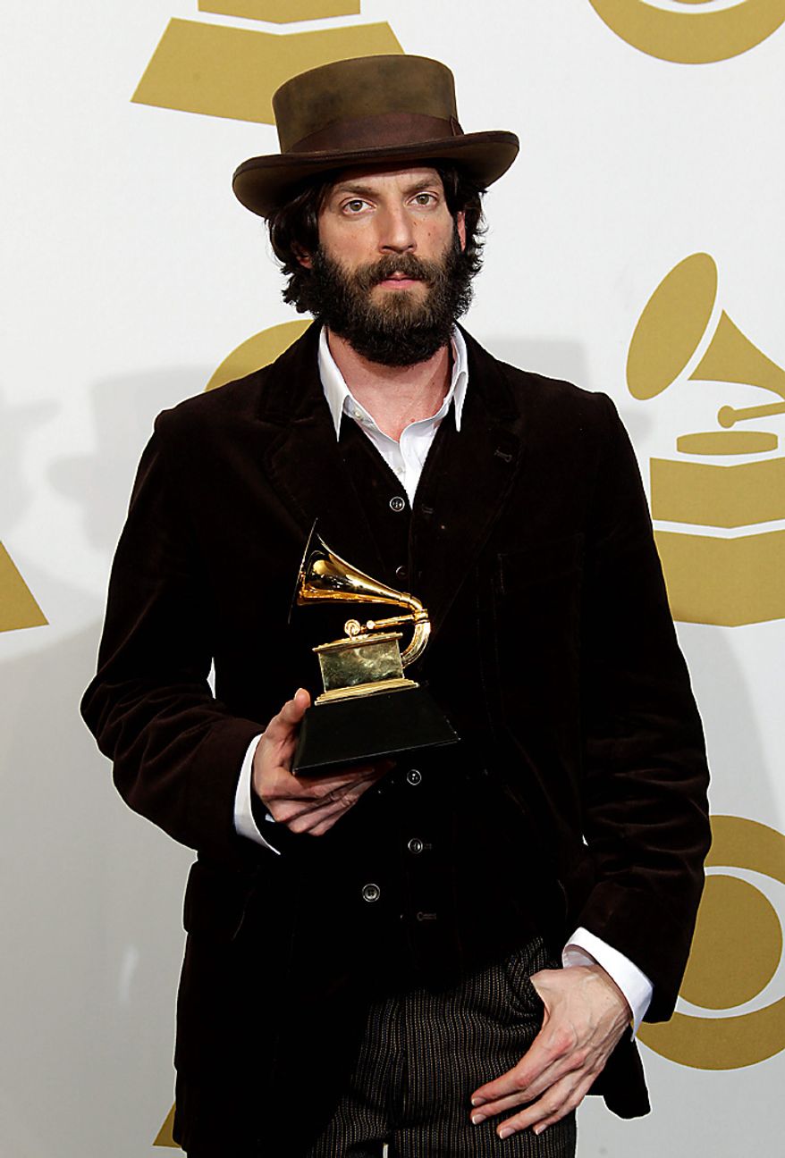 Ray LaMontagne poses backstage with the award for best contemporary folk album at the 53rd annual Grammy Awards on Sunday, Feb. 13, 2011, in Los Angeles. (AP Photo/Jae C. Hong)
