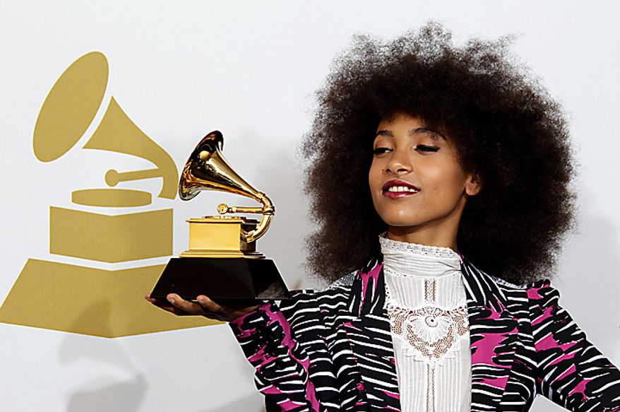 Esperanza Spalding poses backstage with the award for best new artist at the 53rd annual Grammy Awards on Sunday, Feb. 13, 2011, in Los Angeles. (AP Photo/Jae C. Hong)
