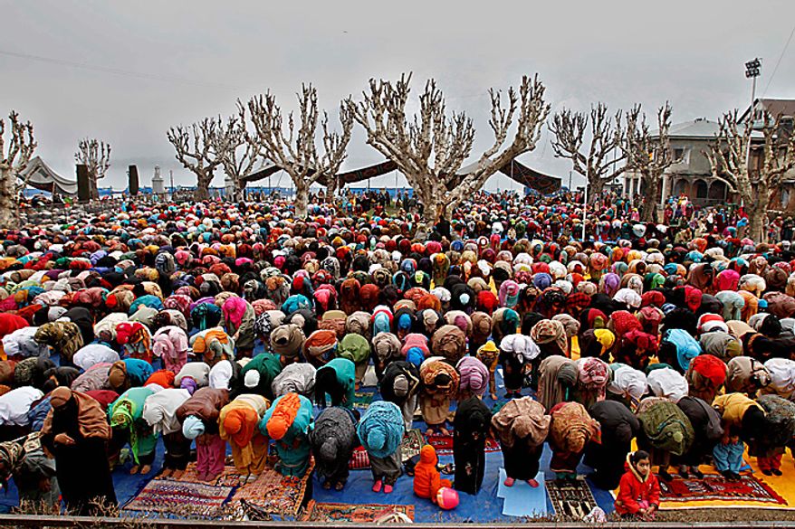 Kashmiri women offer prayers to mark the birth anniversary of the Prophet Muhammed at the Hazratbal Shrine in Srinagar, India, on Wednesday, Feb. 16, 2011. Thousands gathered at the shrine, which houses a relic believed to be a hair from the beard of the Prophet, to offer prayers. (AP Photo/Mukhtar Khan)