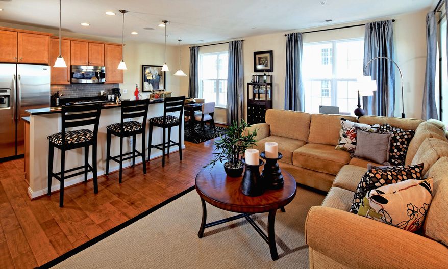 The Dylan model at the Residences at Dulles Parkway Center, a two-level upper-unit town-home-style condominium, has an open family room, center-island kitchen and breakfast area across the back of the main level. It is priced from $326,990 to $336,990.