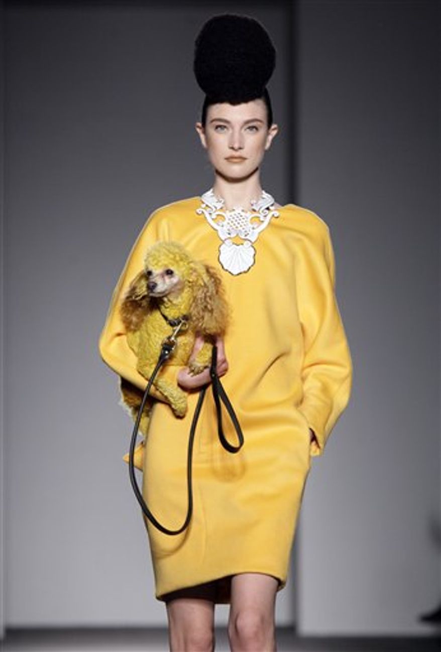 A colorful cake by Buddy Valastro, of Carlo's Bakery in Hoboken N.J., is carried down the runway to match the fall 2011 collection of designer Isaac Mizrahi during Fashion Week in New York, Thursday, Feb. 17, 2011. (AP Photo/Richard Drew)