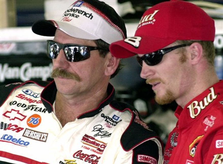 FILE - This Feb. 9, 2001, file photo shows NASCAR drivers Dale Earnhardt, left, and his son Dale Jr., standing together during a break in practice, at the Daytona International Speedway in Daytona Beach, Fla. The 10-year anniversary of his father's death weighs heavily, almost preventing Earnhardt from enjoying the start of a new season. (AP Photo/Paul Kizzle, File)