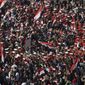 A brass band marches surrounded by demonstrators as people gathers for Friday prayers followed by a demonstration in Tahrir square, Cairo, Egypt, Friday Feb. 18, 2011. (AP Photo/Khalil Hamra)