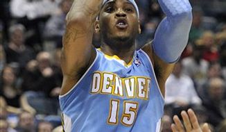 Denver Nuggets&#39; Carmelo Anthony (15) shoots against the Milwaukee Bucks during the first half of an NBA basketball game Wednesday, Feb. 16, 2011, in Milwaukee.  (AP Photo/Jim Prisching)