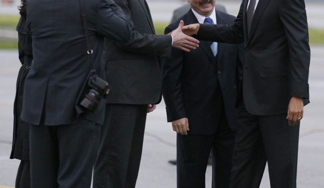 President Obama, right, is greeted by California Lt. Gov. Gavin Newsom, third from right, and San Francisco Mayor Ed Lee as he arrives at San Francisco International Airport Thursday, Feb. 17, 2011. (AP Photo/Carolyn Kaster)