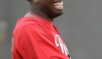 Cincinnati Reds starting pitcher Dontrelle Willis laughs during baseball spring training Friday, Feb. 18, 2011, in Goodyear, Ariz. (AP Photo/Mark Duncan)