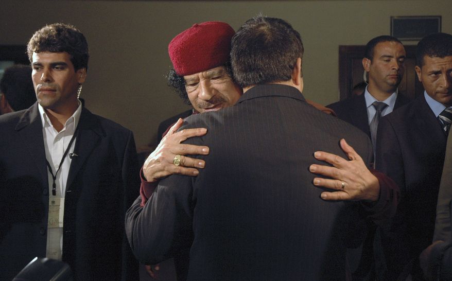 ** FILE ** In this Tuesday, June 10, 2008, file photo, Libyan leader Moammar Gadhafi, facing, embraces Tunisia's then President Zine El Abidine Ben Ali at an Arab mini-summit, in the capital Tripoli, Libya. Libyan special forces stormed a two-day-old protest encampment in the country's second largest city of Benghazi, clearing the area early Saturday, Feb. 19, 2011, said witnesses, as a human rights group estimate scores of people have died in the harsh crackdown on days of demonstrations. (AP Photo/Abdel Meguid Al-Fergany, File)