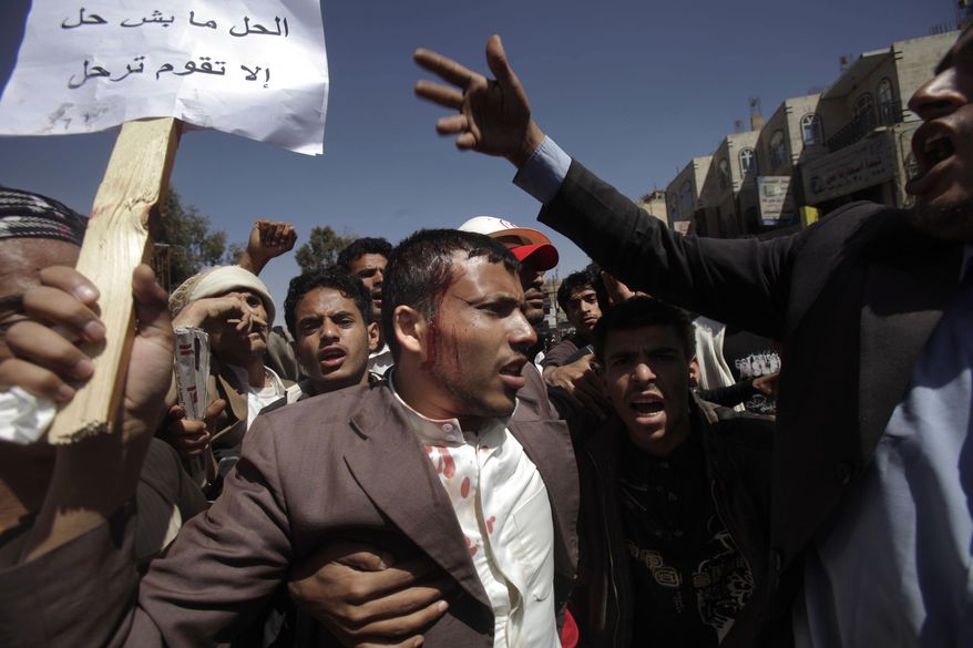 A wounded anti-government demonstrator is helped by other demonstrators after being hit by a stone thrown by Yemeni government supporters during clashes in Sanaa, Yemen, on Saturday, Feb. 19, 2011. Hundreds of Yemenis began demonstrating early in the morning Saturday outside the university in Sanaa, demanding the ouster of the country's longtime ruler as they marched toward the Justice Ministry. (AP Photo/Muhammed Muheisen)