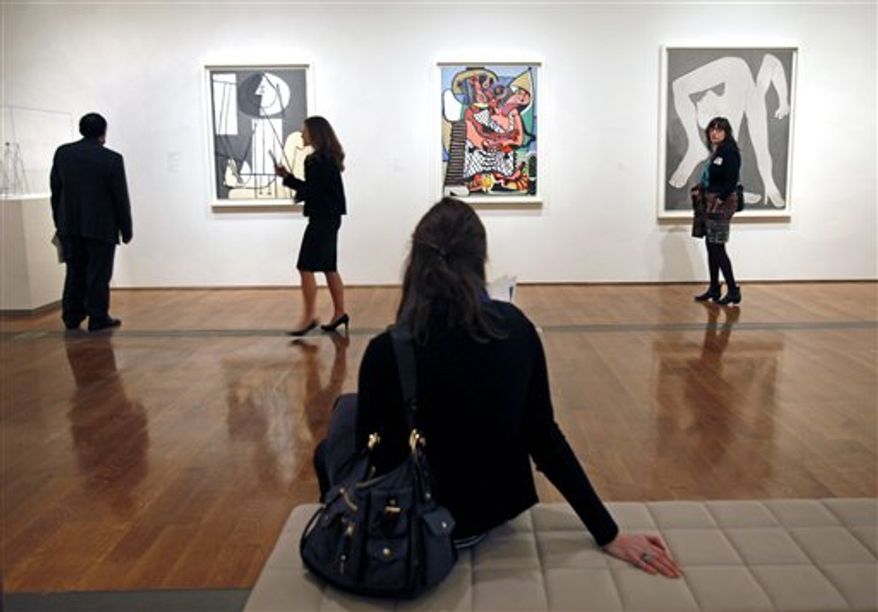 In a Feb. 16, 2011, file photo, visitors at the Virginia Museum of Fine Arts in Richmond, Va., look at paintings by Pablo Picasso at a special preview of the exhibit "Picasso: Masterpieces from Musee National Picasso, Paris." The special exhibit includes 176 works by Picasso, spanning his 80-year career. (AP Photo/ Richmond Times-Dispatch, P. Kevin Morley) ** FILE **