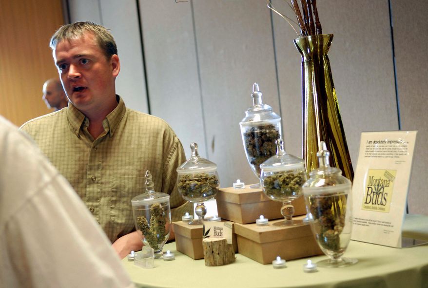 Chuck Campbell, with Montana Buds, talks with a new card holder about the services he offers, as part of a so-called cannabis caravan in Helena, Mont. Some Montanans have had enough of medical marijuana, saying their state's image as a rugged cowboy frontier is being replaced by a fast-growing pot culture. (Associated Press)