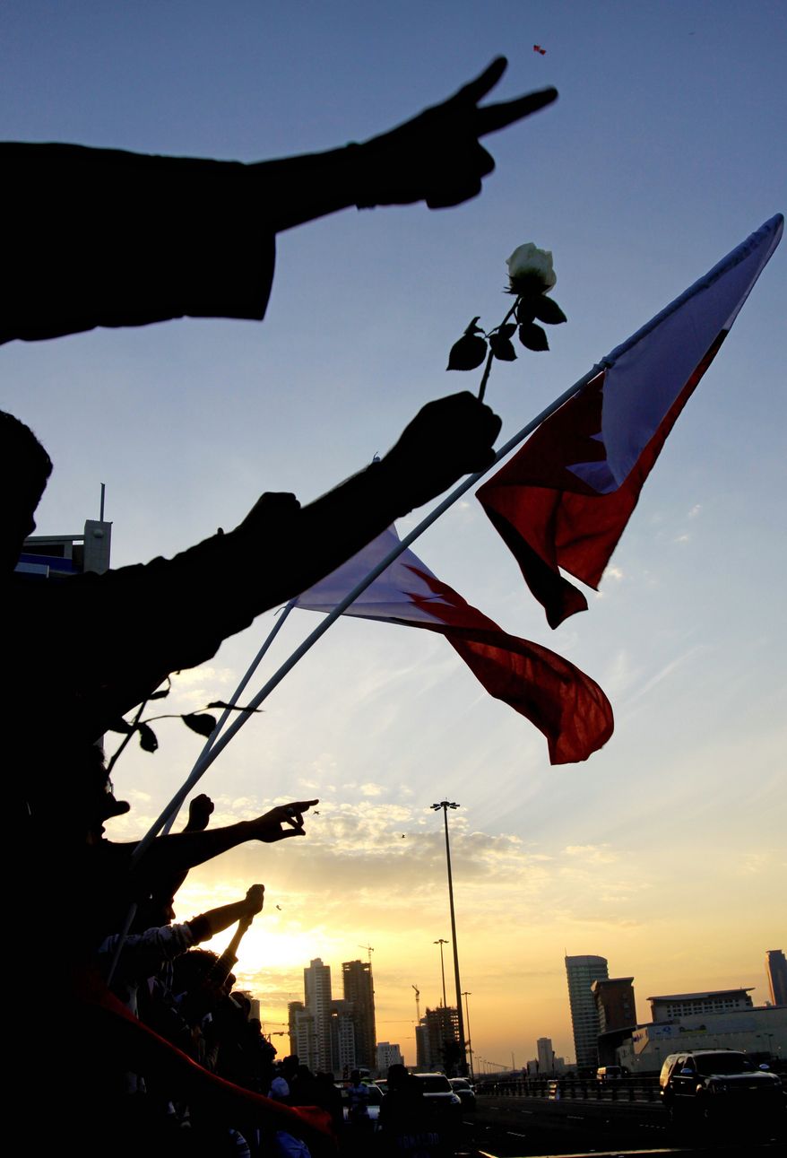 Bahrainis rally on a bridge in Manama on Sunday as Shiite opposition leaders considered an offer for talks with the nation's Sunni rulers. Nearly a week of protests and deadly clashes have sharply divided the strategic Gulf nation, where the U.S. 5th Fleet is based. (Associated Press)