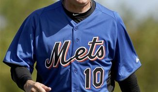 New York Mets first baseman Daniel Murphy, left, laughs as he warms up under the watchful eye of manager Terry Collins during spring training baseball, Monday, Feb. 21, 2011, in Port St. Lucie, Fla. (AP Photo/Jeff Roberson)