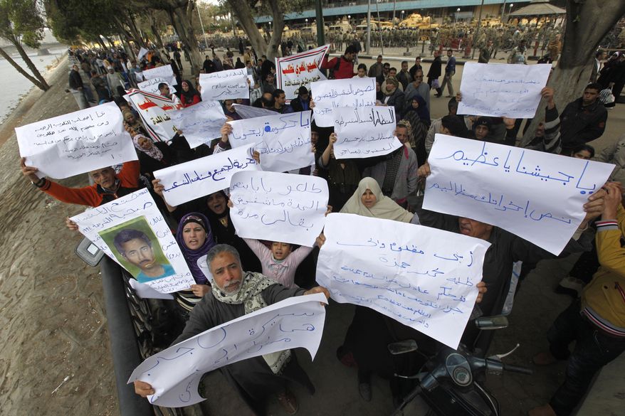 Demonstrators protest in Cairo on Sunday, Feb. 20, 2011, to demand the release of political prisoners in Egyptian jails and of anti-government protesters arrested last week who are still in custody. (AP Photo/Hussein Malla)
