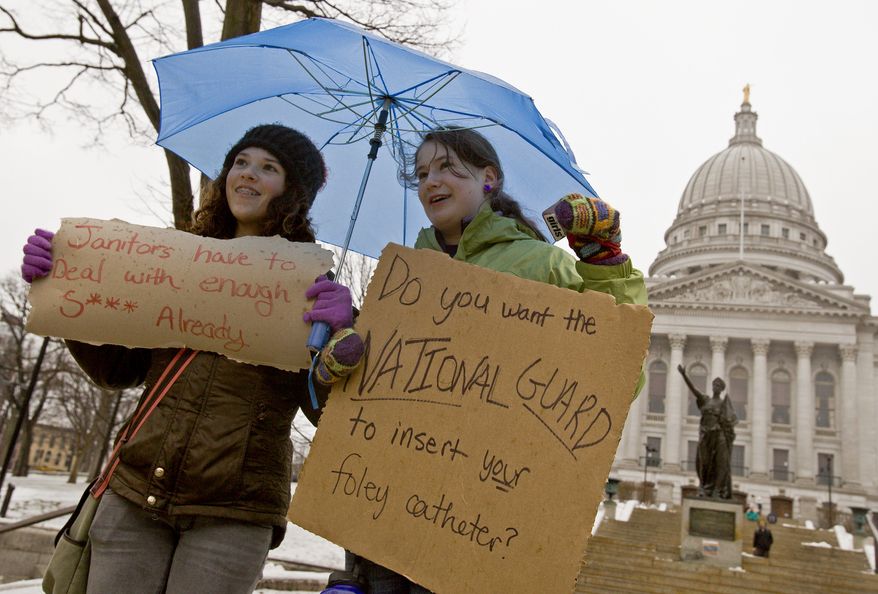 Jane Moran (left), and Emma Rankin-Utevsky, both 14, protest outside the state Capitol in Madison, Wis., on Sunday, Feb. 20, 2011. (AP Photo/Andy Manis)