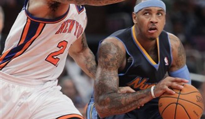 In this Dec. 12, 2010, photo, Denver Nuggets&#x27; Carmelo Anthony, right, works against New York Knicks&#x27; Wilson Chandler during an NBA basketball game in New York. Anthony acknowledged after his 38-point performance in Milwaukee on Wednesday night, Feb. 16, that he has no idea what will happen as trade talks surely intensify this All-Star weekend. &quot;I&#x27;m waiting to see just like (everybody else),&quot; he said. (AP Photo/Seth Wenig)