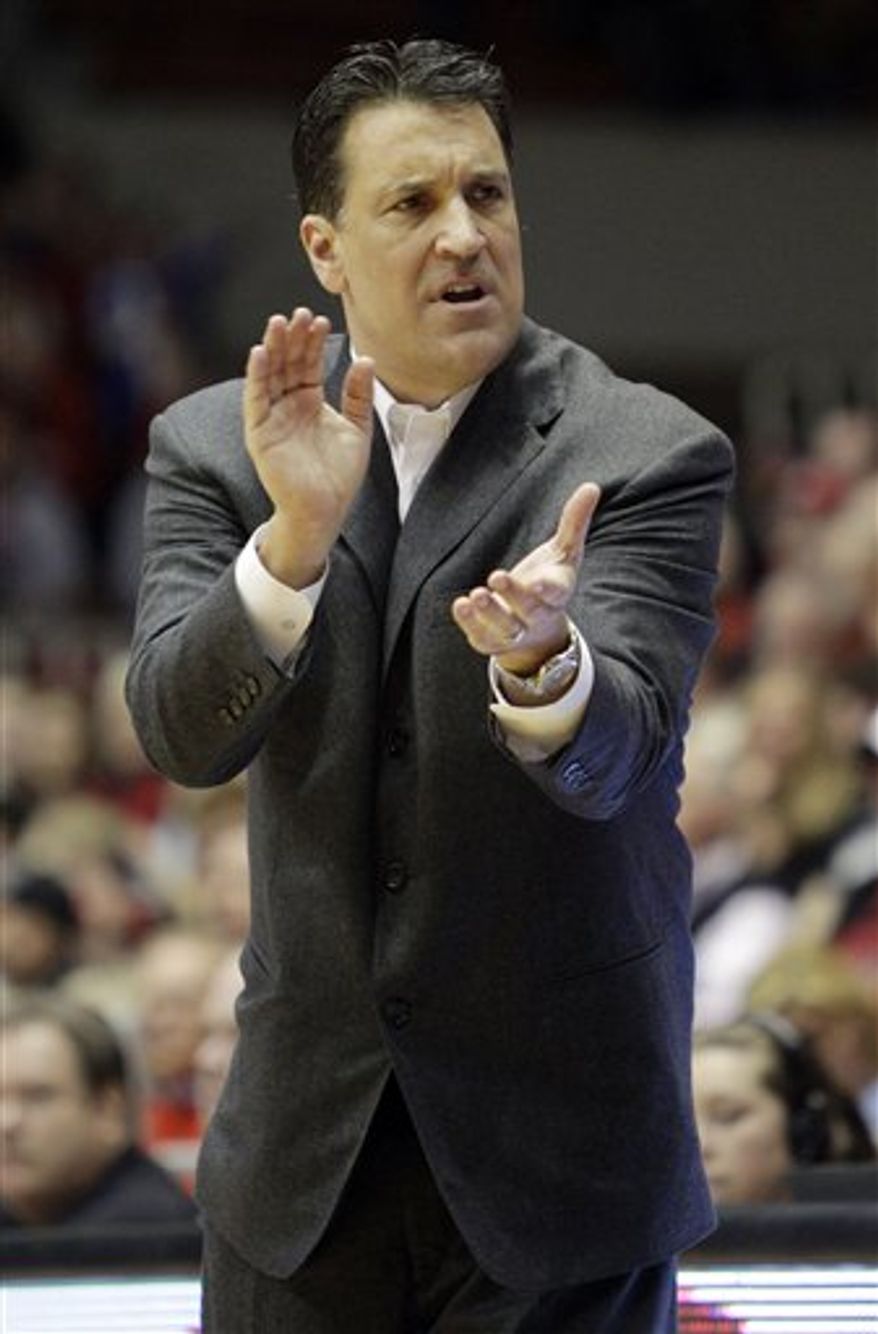 FILE - In this Feb. 13, 2011, file photo, St. John's head coach Steve Lavin urges his team on during an NCAA college basketball game against Cincinnati in Cincinnati. Lavin has more than lived up to the hype surrounding his move from the TV table to coaching St. John's. Just check the Top 25. (AP Photo/Al Behrman, File)