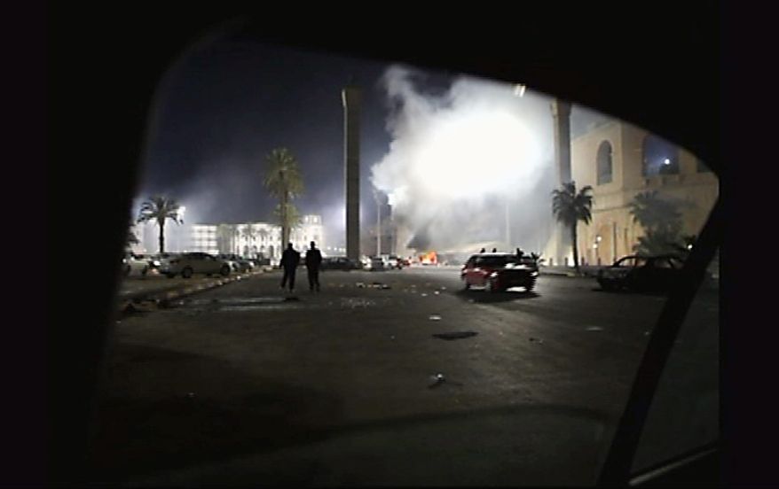 A fire burns in a street in the Libyan capital Tripoli in the early hours Tuesday Feb. 22, 2011, in this image taken from TV. The bodies of protesters shot to death by forces loyal to Moammar Gadhafi were left on the streets of a restive district in the Libyan capital Tuesday, an opposition activist and a resident said, while the longtime leader defiantly went on state TV to show he was still in charge. (AP Photo/APTN)