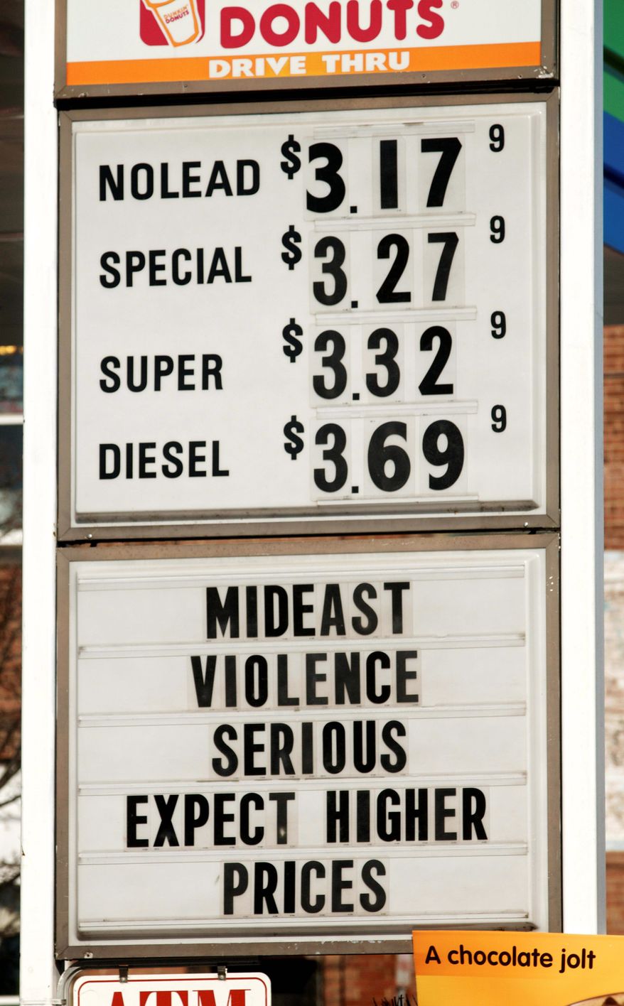 A sign advertises gas and diesel prices, plus gives an explanation to customers, at a service station in Easthampton, Mass., on Wednesday. (Associated Press)