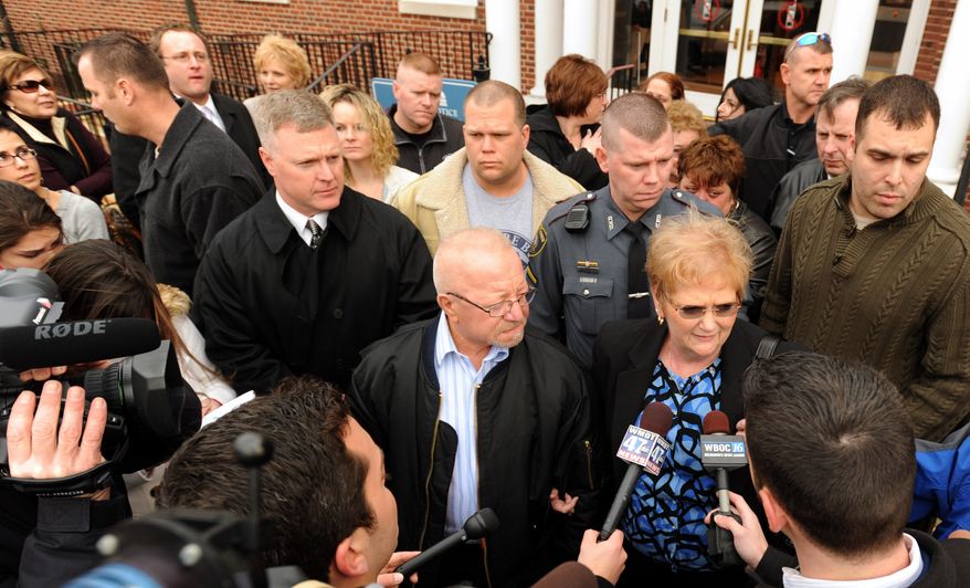 ** FILE ** Norman and Ruth Ann Spicer talk with the media outside the courthouse in Georgetown, Del., on Tuesday, Feb. 8, 2011, after a jury convicted Derrick Powell of Cumberland, Md., of the murder of the Spicers' son, Georgetown Patrolman Chad Spicer. On Wednesday, the same jury recommended that Powell be sentenced to death. (AP Photo/Wilmington News-Journal, Gary Emeigh)
