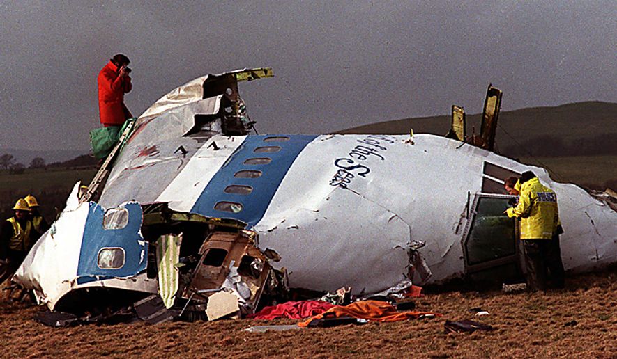 In this Dec 22, 1988 file photo Police and investigators look at what remains of the flight deck of Pan Am 103 on a field in Lockerbie, Scotland. Swedish tabloid Expressen said Wednesday Feb. 23, 2011 that Libya's recently resigned justice minister claims Moammar Gadhafi personally ordered the Lockerbie bombing that killed 270 people in 1988. Expressen quotes Mustafa Abdel-Jalil as telling their correspondent in Libya that "I have proof that Gadhafi gave the order about Lockerbie." The comments were translated from Arabic to Swedish. (AP Photo/File)