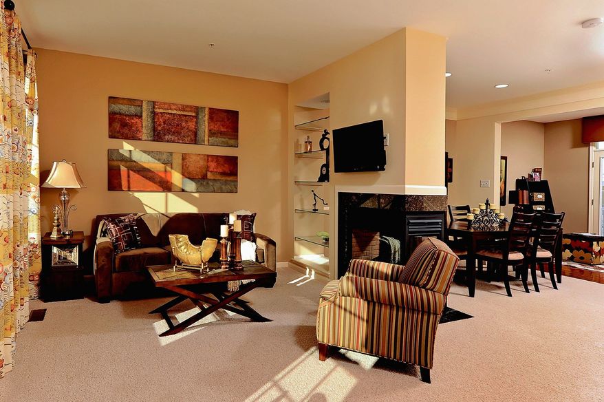 An optional gas fireplace separates the living and dining rooms in the Maya's Manor model at the Landing at Emerson. The model has 1,935 square feet and is priced from the $340,000s.
