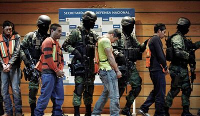 Soldiers escort Julian Zapata Espinosa (fourth right), also known as &quot;El Piolin,&quot; identified as a member of the Los Zetas drug cartel and the main suspect in the killing of U.S. Immigration and Customs Agent Jaime Zapata. Jesus Ivan Quesada Pena (left), Mario Dominguez Realeo, Domingo Diaz Rosas (third left) and Honduras&#39; citizen Ruben Dario Venegas are also escorted during a presentation for the media in Mexico City on Wednesday. Agent Zapata and fellow agent Victor Avila were attacked Feb. 15 when traveling along a highway in Mexico&#39;s San Luis Potosi state. Agent Avila survived the attack. (Associated Press)