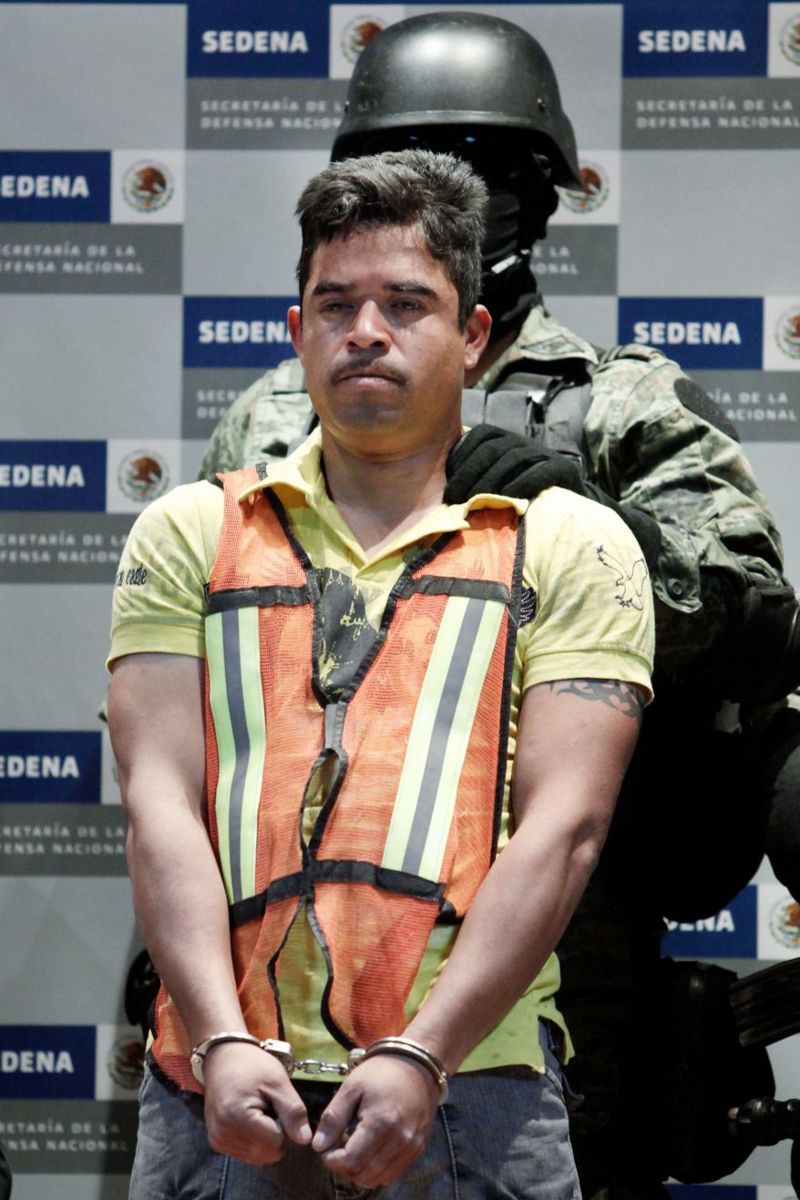 'TWEETY BIRD' DETAINED: A soldier escorts Julian Zapata Espinoza in Mexico City on Wednesday. (Associated Press)