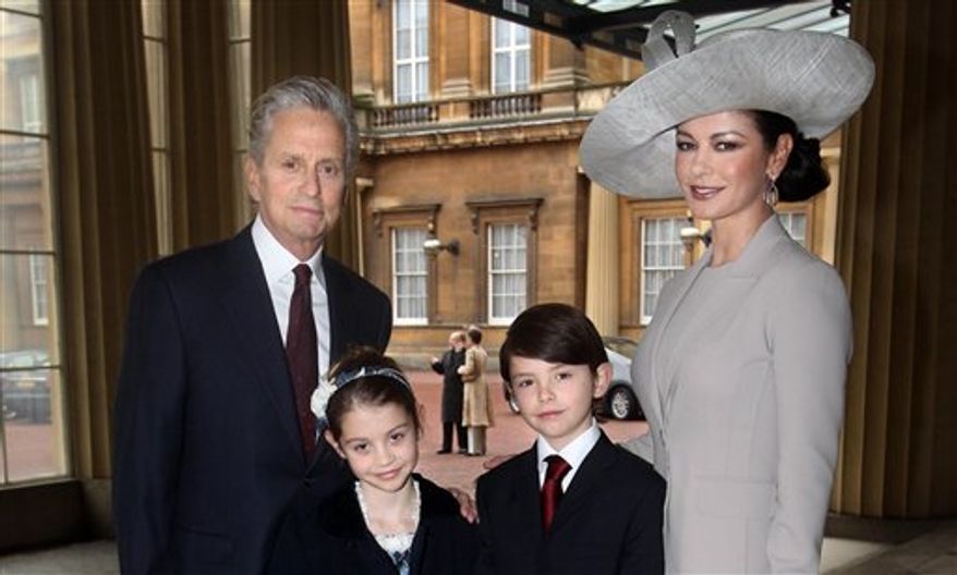 Hollywood actress Catherine Zeta Jones, right, and her husband Michael Douglas, with their children Dylan and Carys, arrive at Buckingham Palace in London where Catherine Zeta Jones will be invested with the royal award as a CBE (Commander of the Order of the British Empire) by the Prince of Wales, Thursday Feb. 24, 2011. The Welsh-born actress who became an Oscar-winning star will receive the honour for services to the film industry and to charity. (AP Photo / Lewis Whyld)