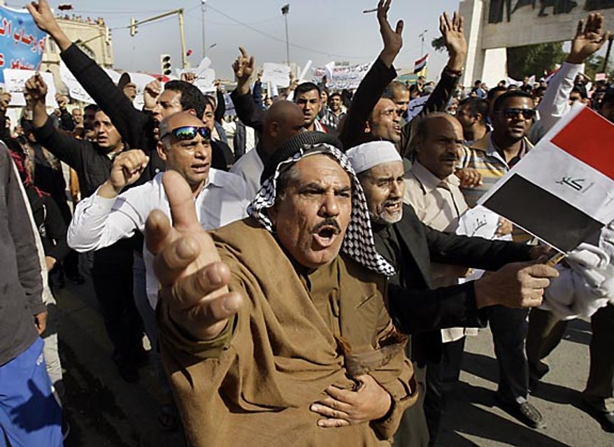 Protesters chant anti-Iraqi government slogans during a protest at Tahrir Square in Baghdad Friday, Feb. 25, 2011. Iraqi security forces trying to disperse crowds of demonstrators in northern Iraq killed a few people Friday as thousands rallied in cities across the country during what has been billed as the "Day of Rage." (AP Photo/Khalid Mohammed)