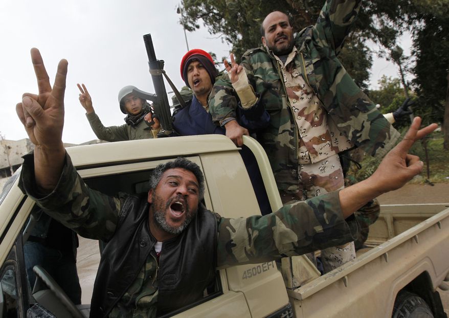 Rebels opposed to Libyan leader Moammar Gadhafi celebrate the freedom of the Libyan city of Benghazi on Sunday, Feb. 27, 2011. President Obama has called on Col. Gadhafi to relinquish power immediately, saying he has lost the legitimacy to rule with his violent crackdown on his own people. (AP Photo/Hussein Malla)