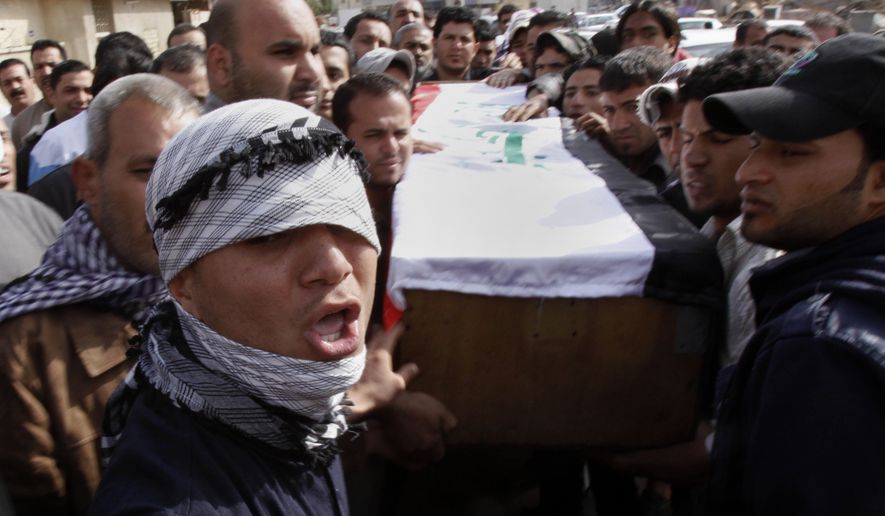 Relatives of Salim Farooq, 18, carry his coffin during his funeral procession in Basra, Iraq, the country&#39;s second-largest city, on Saturday, Feb. 26, 2011. Farooq was killed on Friday during a demonstration in Basra, his family said. (AP Photo/Nabil al-Jurani)
