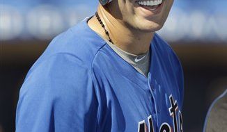 New York Mets pitcher Oliver Perez (46) wipes his face after giving up his second home run during the seventh inning of a spring training baseball game against the Washington Nationals, Saturday, March 19, 2011 in Port St. Lucie, Fla. (AP Photo/Carlos Osorio)