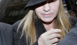 FILE - In this Monday, Feb. 28, 2011 file photo, Fashion designer John Galliano arrives at a police station in Paris. Christian Dior have fired Galliano  in wake of alleged anti-Semitic remarks he made during a dispute at a trendy Paris cafe. (AP Photo/Michel Euler, File)
