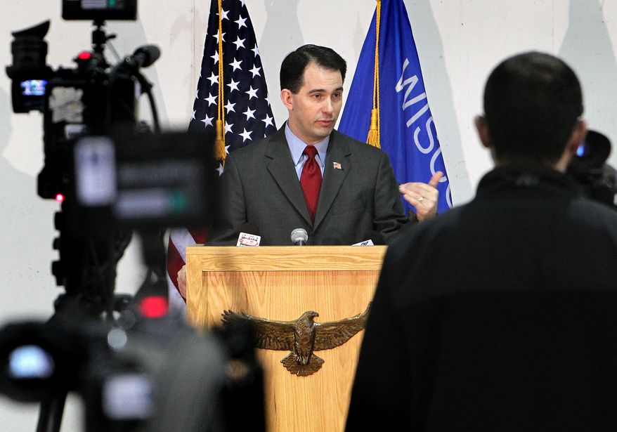 Wisconsin Gov. Scott Walker addresses the media at a news conference at Colgan Air Services at the La Crosse Municipal Airport in La Crosse, Wis., on Monday, Feb. 28, 2011. The governor called on the missing Democratic state senators to return to Madison, the state capital. (AP Photo/La Crosse Tribune, Erik Daily)