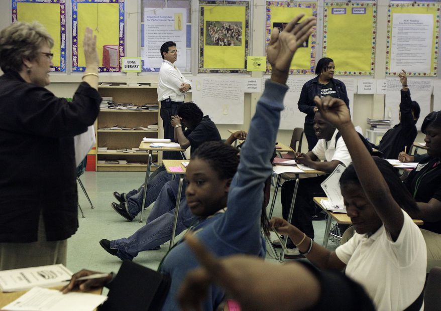 **FILE** Four teachers help 20 students prepare for the Florida Comprehensive Assessment Test by giving them reading strategies at Miami Central Senior High School in Miami on Feb. 27, 2009. (Associated Press/The Miami Herald)
