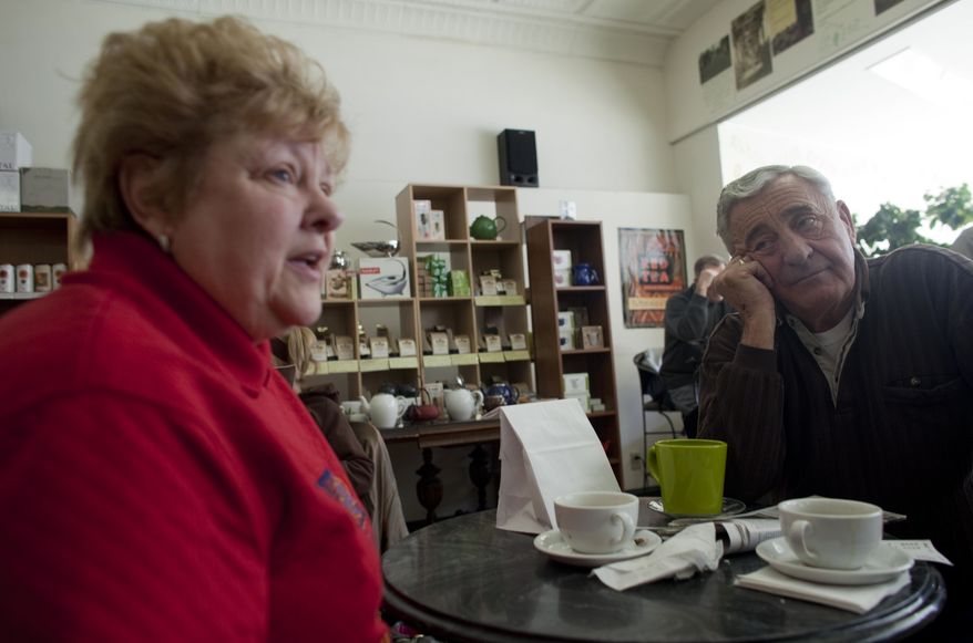 In this March 2, 2011, photo, Nancy, left, and her husband Harry Harrington talk about the Wisconsin budget crisis at Wilson's Coffee & Tea in Racine, Wis. Harry now blames years of union demands for an exodus of manufacturing jobs from this blue-collar city on the shore of Lake Michigan. (AP Photo/Darren Hauck)