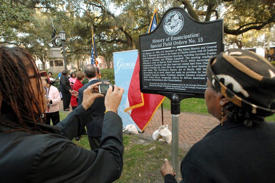 People take photographs of the new "History of Emancipation: Special Field Orders No. 15" historical marker on Friday in Savannah, Ga. (Associated Press)