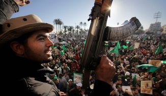 Gadhafi supporters gather to celebrate at Green Square in Tripoli on Sunday. The dictator&#39;s security forces control access to ammunition and reportedly take it away from soldiers not in combat. (Associated Press)