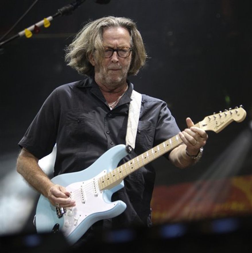 FILE - In this June 26, 2010 file photo, Eric Clapton performs during the Crossroads Guitar Festival in Chicago. Eric Clapton is parting with dozens of guitars and amps at a New York City auction to benefit an alcohol and drug treatment center he founded in Antigua. New York-Bonhams will offer the 70 guitars and 70 amps next Wednesday, March 9, 2011. (AP Photo/Kiichiro Sato, File)