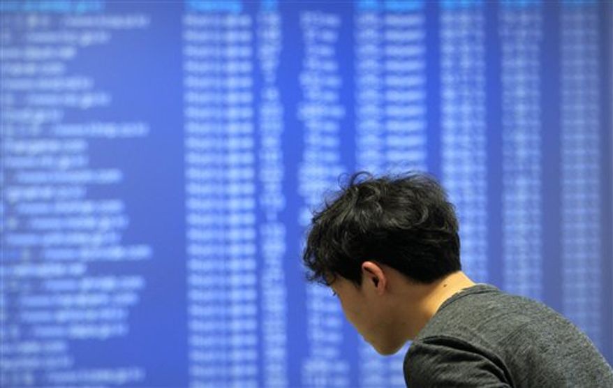 A technician of AhnLab Inc. works against cyberattacks at the company's Security Operation Center in Seoul, South Korea, Friday, March 4, 2011. Hackers attacked about 40 South Korean government and private websites Friday, prompting officials to warn of a substantial threat to the country's computers. (AP Photo/Lee Jin-man)