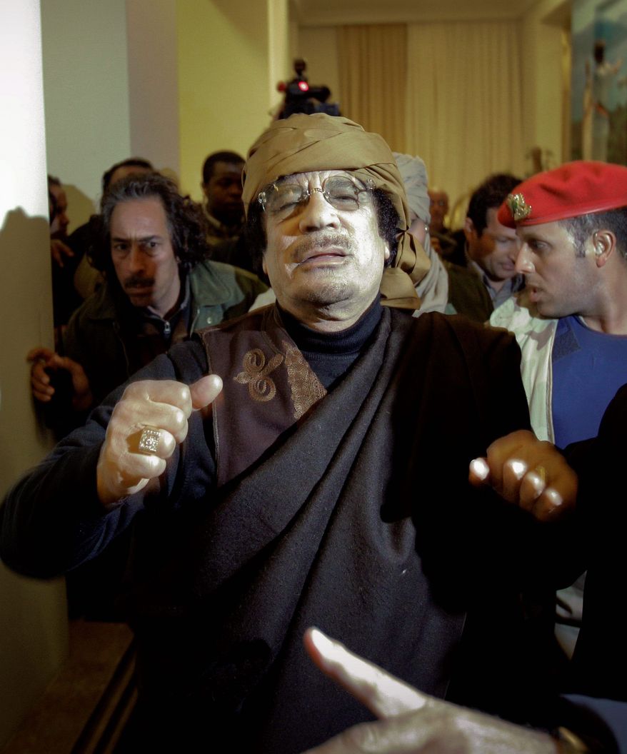 Col. Gadhafi traveled to a hotel in Tripoli on Tuesday to give television interviews while talks in Washington were about whether to establish a no-fly zone over his country. (Associated Press)