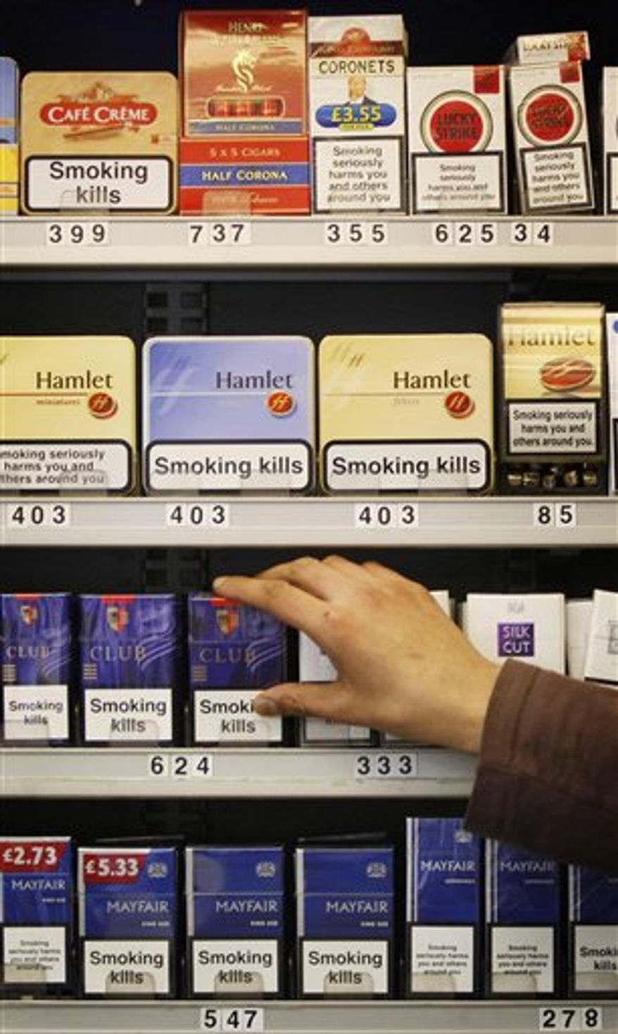 FILE -- In this June 29, 2010 file photo, tobacco products are displayed in a shop in Glasgow, Scotland. Tobacco will no longer be displayed in shops under new legislation being implemented by Britain's Government in was announced in London, Wednesday May 9, 2011. Only temporary displays in "certain limited circumstances" will be allowed, with the rules phased in to minimise the impact on businesses, according to a statement from the Department of Health.(AP Photo/Danny Lawson, pa, file) UNITED KINGDOM OUT: NO SALES: NO ARCHIVE: