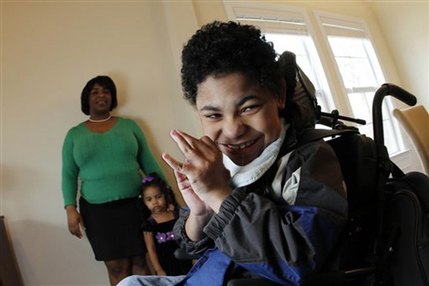 Garrison Diaz, 8, waits on this mother Beatrice Diaz after arriving home from school in Chapel Hill, N.C., Wednesday, March 9, 2011. Diaz unexpectedly went into labor at 24 weeks while pregnant with Garrison, who after delivery was so fragile she was not even allowed to hold him for a month. Today he is in a wheelchair and has the mental capacity of a 9-month old. (AP Photo/Jim R. Bounds)