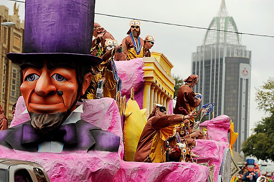 Maskers with the Knight of Revelry tosses beads to the crowds gathered on Government Street in Mobile, Ala., Tuesday, March 8, 2011, for the pre-Lenten blowout along the Gulf Coast called Fat Tuesday. (AP Photo/Press-Register, John David Mercer)
