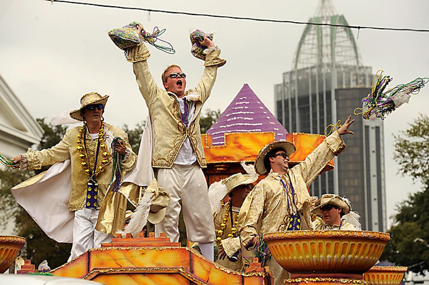 Knights of King Felix III court toss beads to the crowds gathered on Government Street in Mobile, Ala., Tuesday, March 8, 2011, for the pre-Lenten blowout along the Gulf Coast called Fat Tuesday. (AP Photo/Press-Register, John David Mercer)