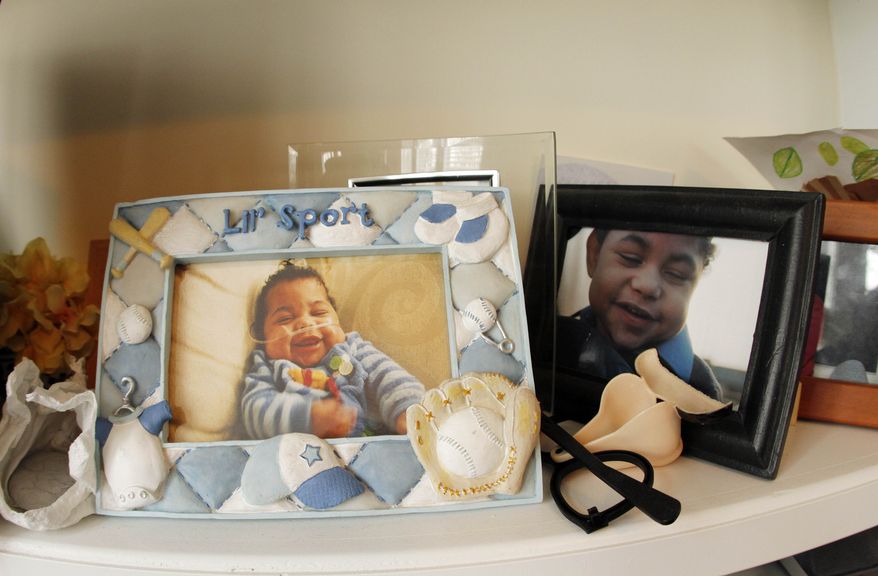 Photographs displayed of her of Beatrice Diaz's son on Garrison Diaz, 8, are shown at her home in Chapel Hill, N.C., on Wednesday, March 9, 2011. Diaz unexpectedly went into labor at 24 weeks while pregnant with Garrison, who after delivery was so fragile she was not even allowed to hold him for a month. Today, he is in a wheelchair and has the mental capacity of a 9-month old. (AP Photo/Jim R. Bounds)