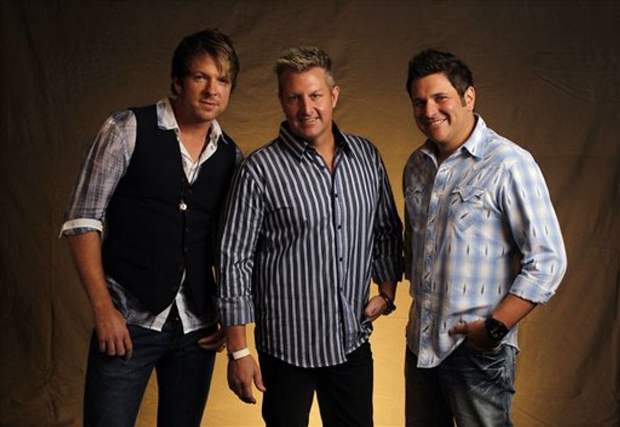 FILE - This Sept. 29, 2010 photo shows Joe Don Rooney, left, Gary Levox, and Jay DeMarcus, right, of Rascal Flatts in Nashville, Tenn. (AP Photo/Mark Humphrey, file)